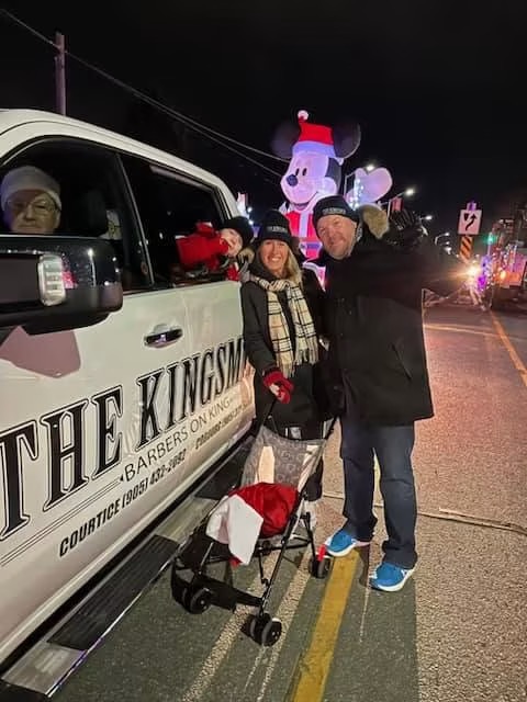 Lindsay Grimley and family at the Cobourg Santa Claus parade with The Kingsmen Barbers truck