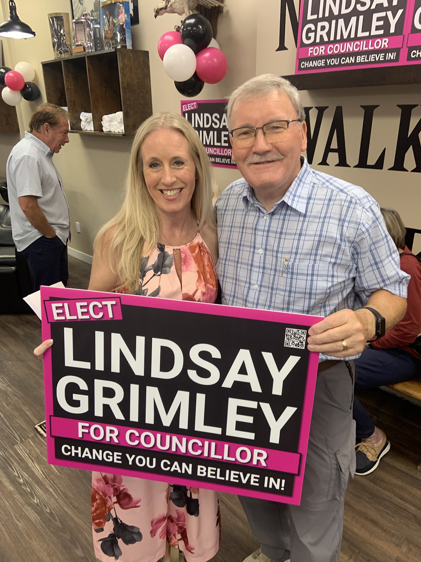 Lindsay Grimley and a supporter holding an Elect Lindsay Grimley for Councillor sign